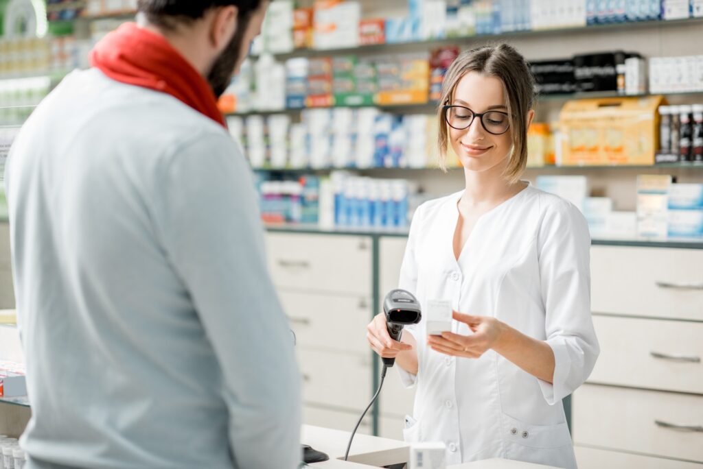 Pharmacist selling medications in the pharmacy store